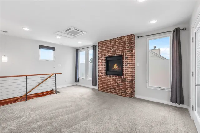 a view of an empty room with a fireplace