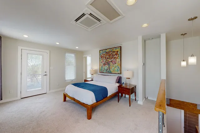 a bedroom with a bed and a painting on the wall