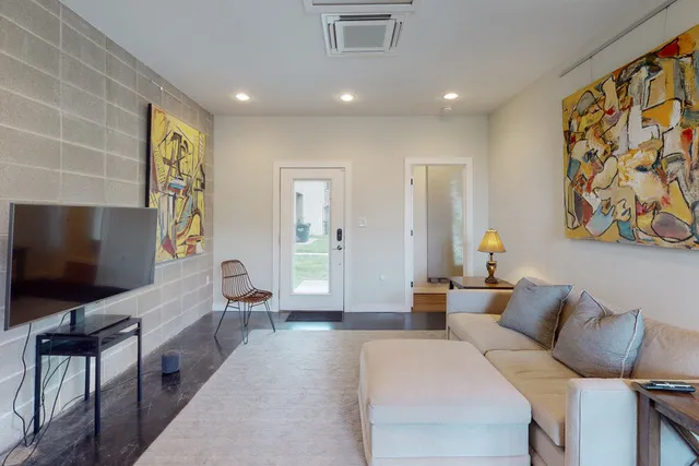a living room with furniture and a flat screen tv