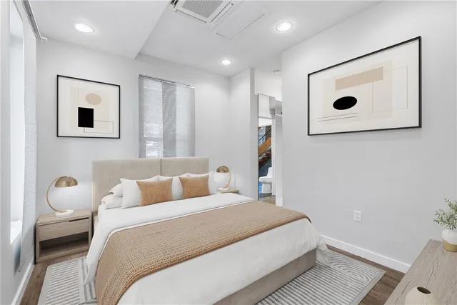 a bedroom with a bed and a wall painting