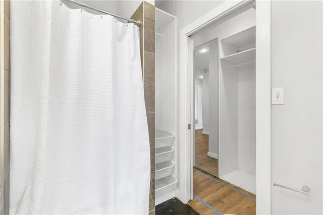 a bathroom with a shower and a sink