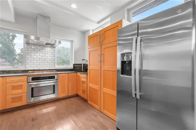 a kitchen with a refrigerator and a stove