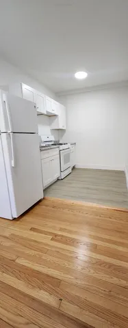 a view of a room with wooden floor