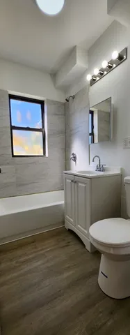 a bathroom with a toilet a sink and mirror