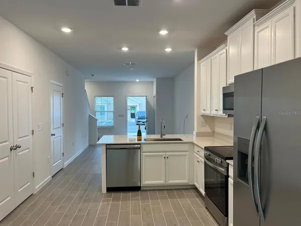 a kitchen with a sink stainless steel appliances and cabinets