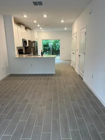 a view of a kitchen with a sink and cabinets