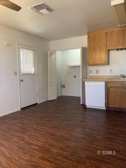345 South Fountain Street Ridgecrest, CA 93555 - Photo 6 of 24 a view of a kitchen with a sink and dishwasher wooden floor