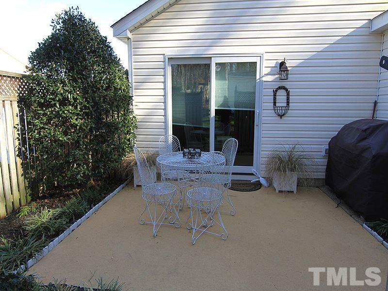 5121 Silverdene Street Raleigh, NC 27616 - Photo 11 of 12 a view of a patio with table and chairs and potted plants