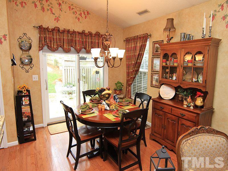 5121 Silverdene Street Raleigh, NC 27616 - Photo 4 of 12 a view of a dining room with furniture and wooden floor