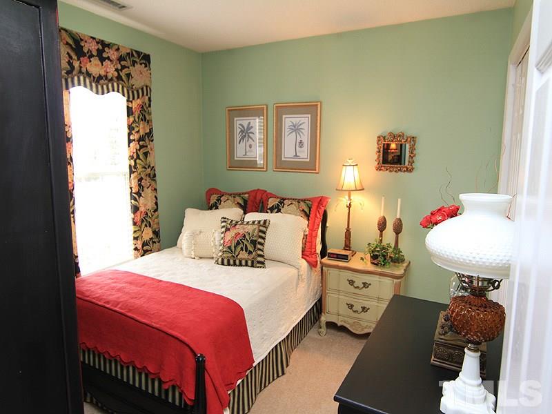 5121 Silverdene Street Raleigh, NC 27616 - Photo 8 of 12 a bedroom with a bed and a table
