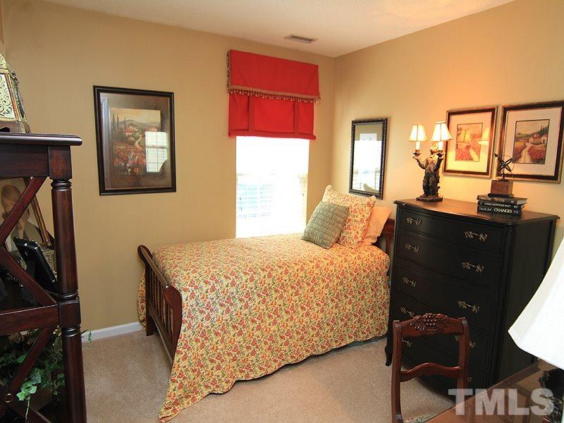 5121 Silverdene Street Raleigh, NC 27616 - Photo 9 of 12 a bedroom with a bed and wooden floor