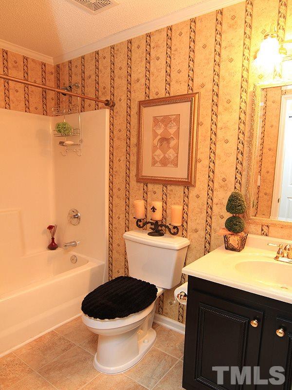 5121 Silverdene Street Raleigh, NC 27616 - Photo 10 of 12 a bathroom with a sink a toilet and a bathtub