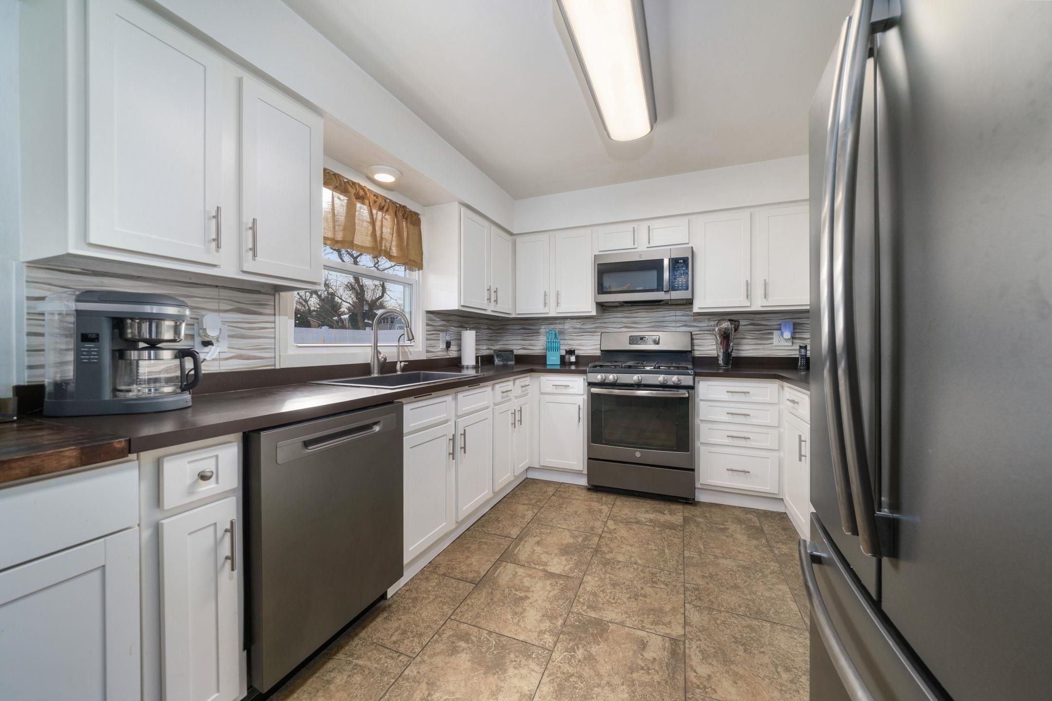 5393 Lakecrest Road Caledonia, IL 61011 - Photo 12 of 40 a kitchen with granite countertop a refrigerator and a sink
