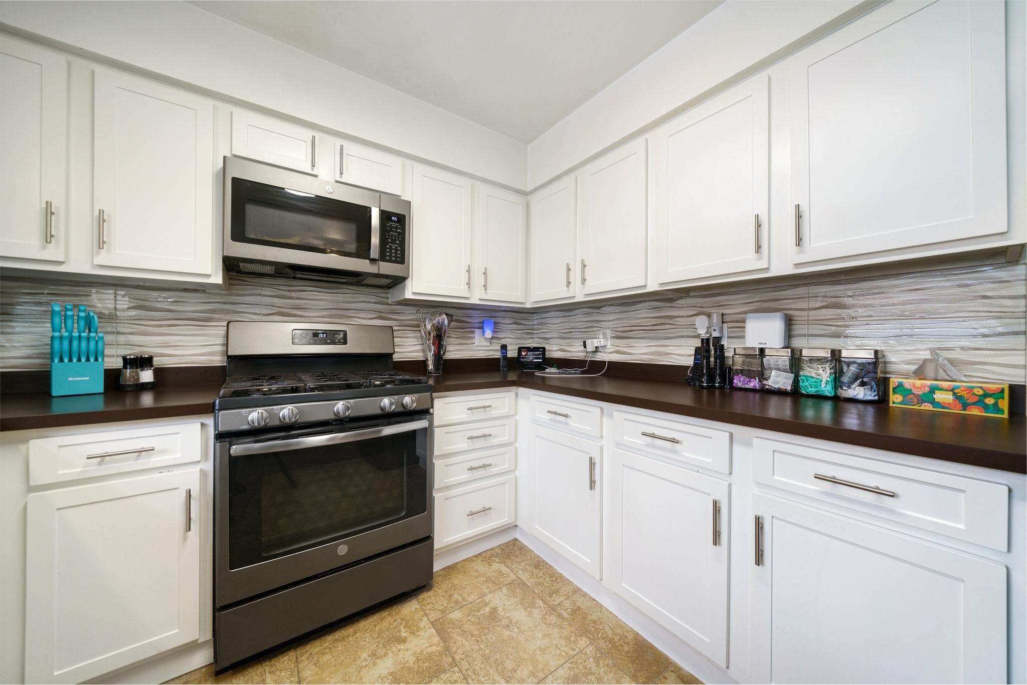 5393 Lakecrest Road Caledonia, IL 61011 - Photo 15 of 40 a kitchen with white cabinets stainless steel appliances and sink