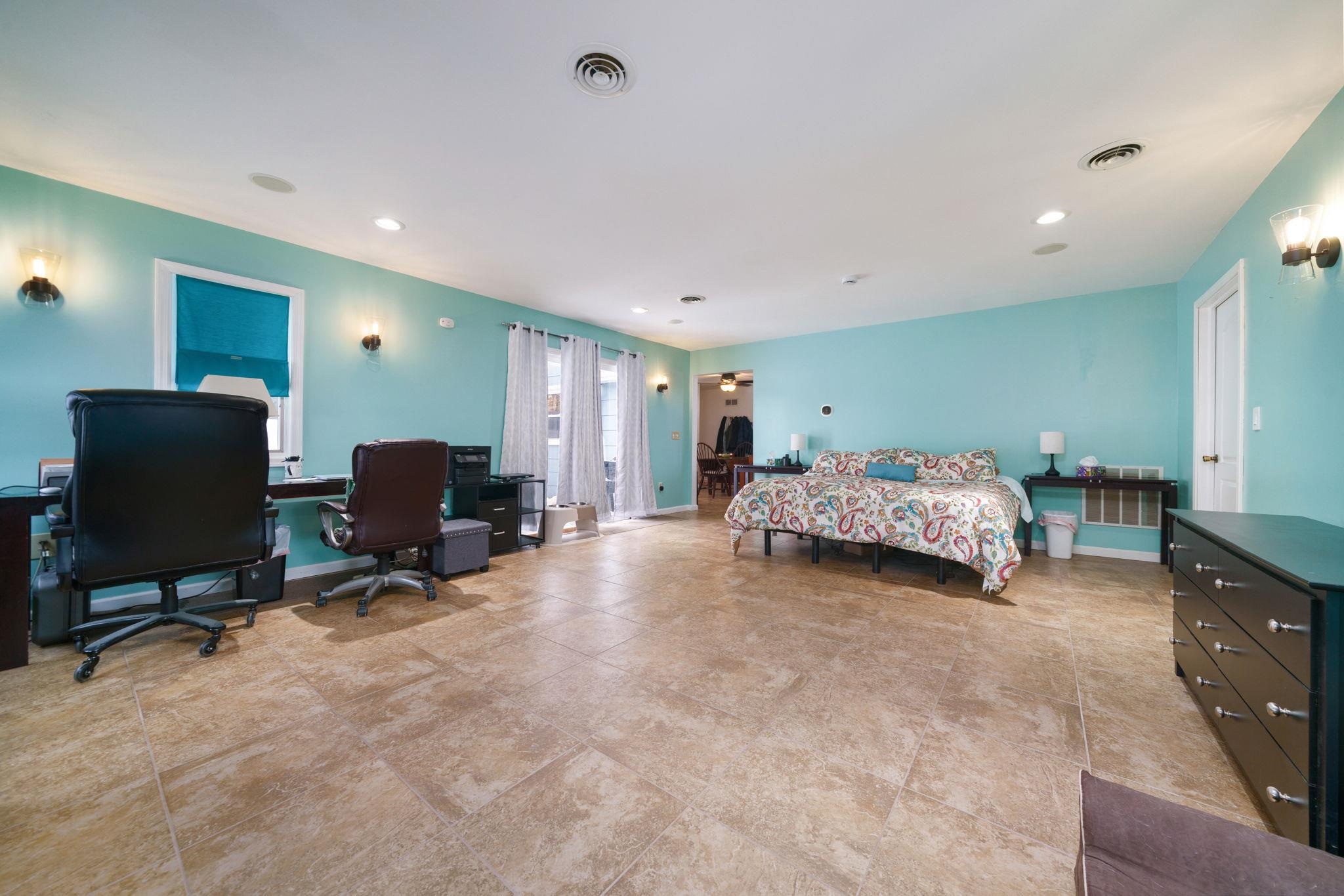 5393 Lakecrest Road Caledonia, IL 61011 - Photo 20 of 40 a spacious bedroom with a bed a desk and chair