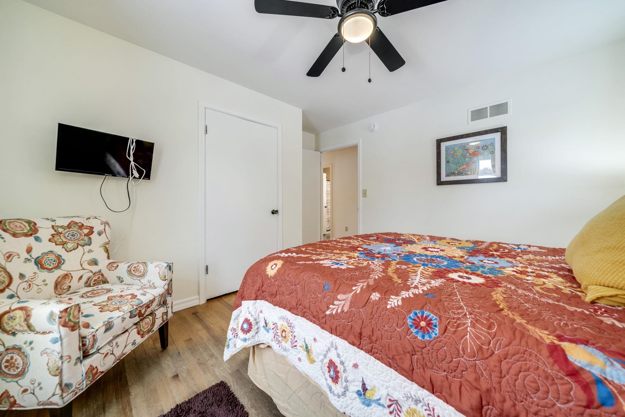 5393 Lakecrest Road Caledonia, IL 61011 - Photo 23 of 40 a bedroom with a bed and flat screen tv