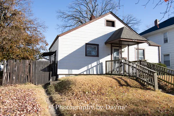 a view of a house with wooden fence
