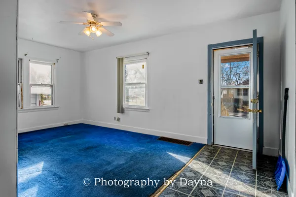 a view of an empty room and wooden floor