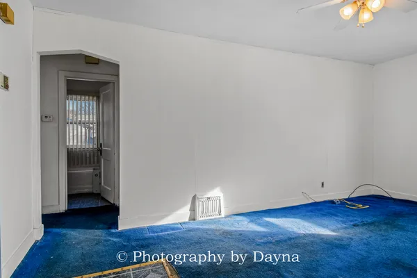 an empty room with window and wooden floor