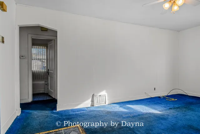 an empty room with window and wooden floor