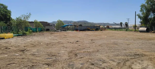 a view of a building with a yard and a mountain view