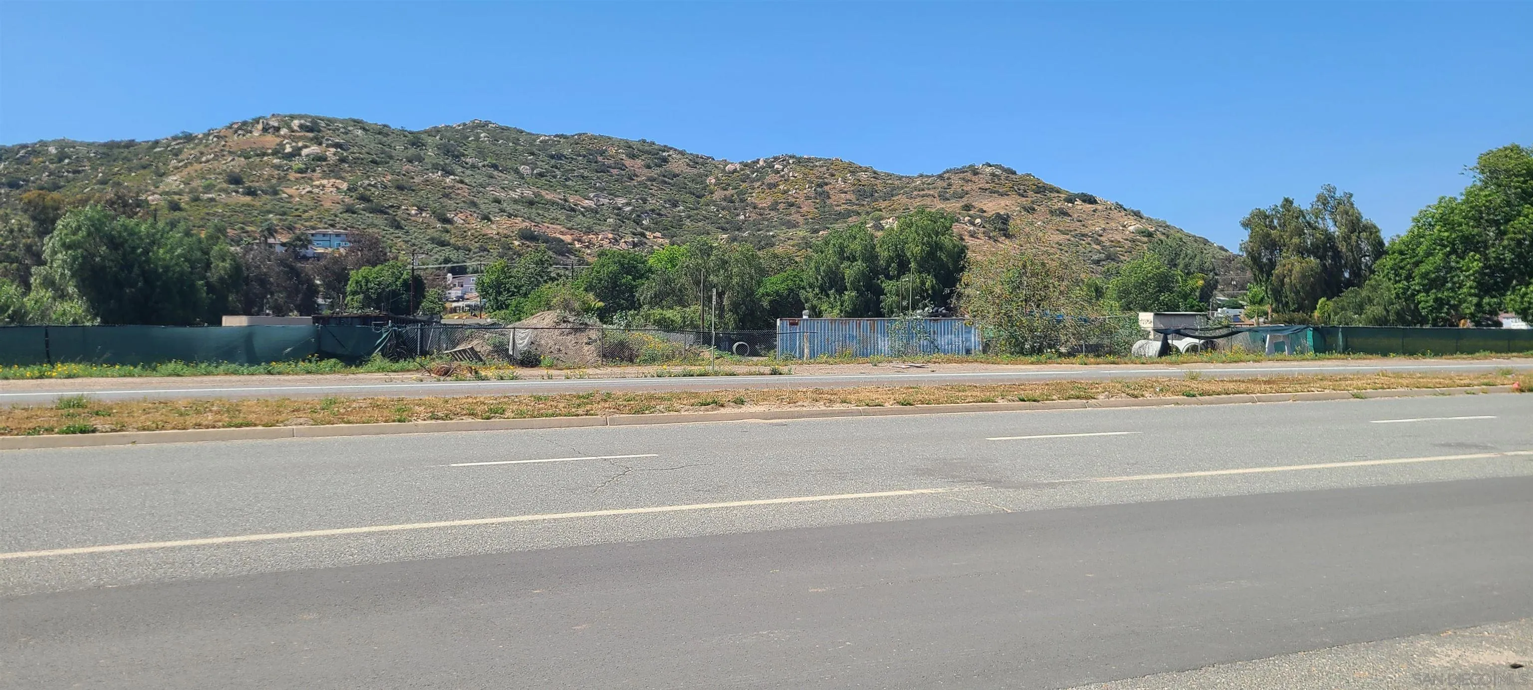 11457 El Nopal Lakeside, CA 92040 - Photo 14 of 14 a view of a building with a yard and a mountain view