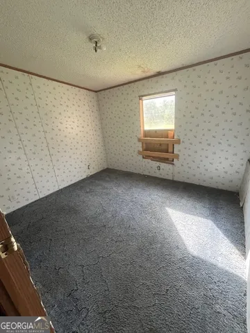 a view of a livingroom with an empty space and a window