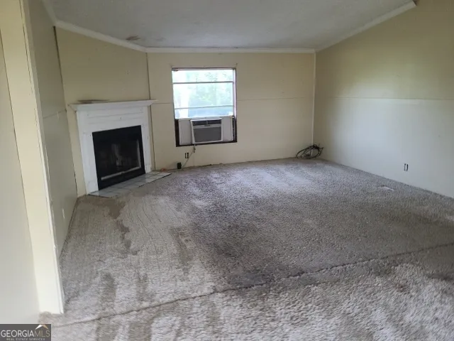 a view of empty room with a fireplace