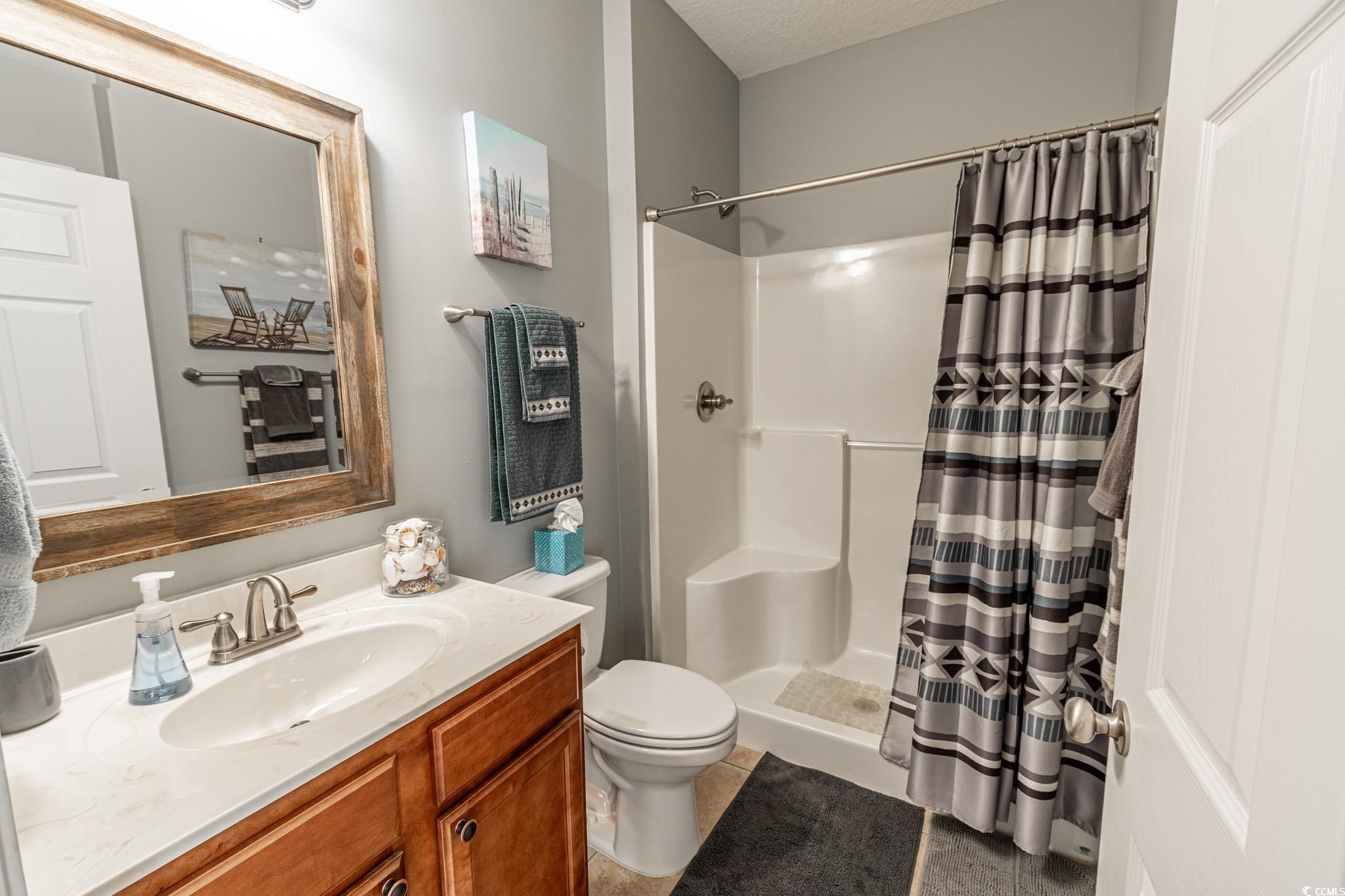 828 Sail Lane, Unit 203 Murrells Inlet, SC 29576 - Photo 21 of 26 Bathroom with tile patterned floors, toilet, a sho