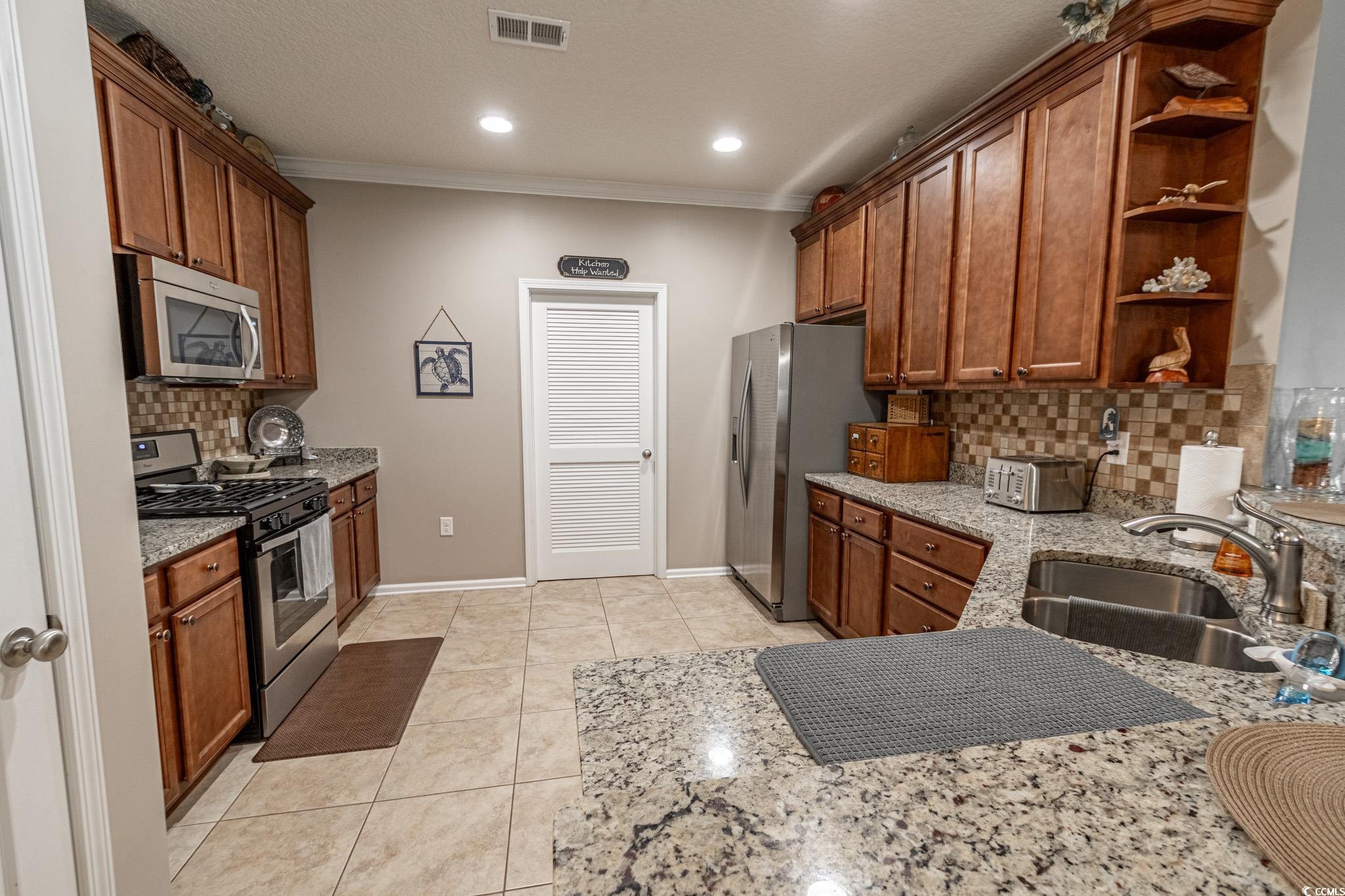 828 Sail Lane, Unit 203 Murrells Inlet, SC 29576 - Photo 8 of 26 Kitchen with backsplash, appliances with stainless