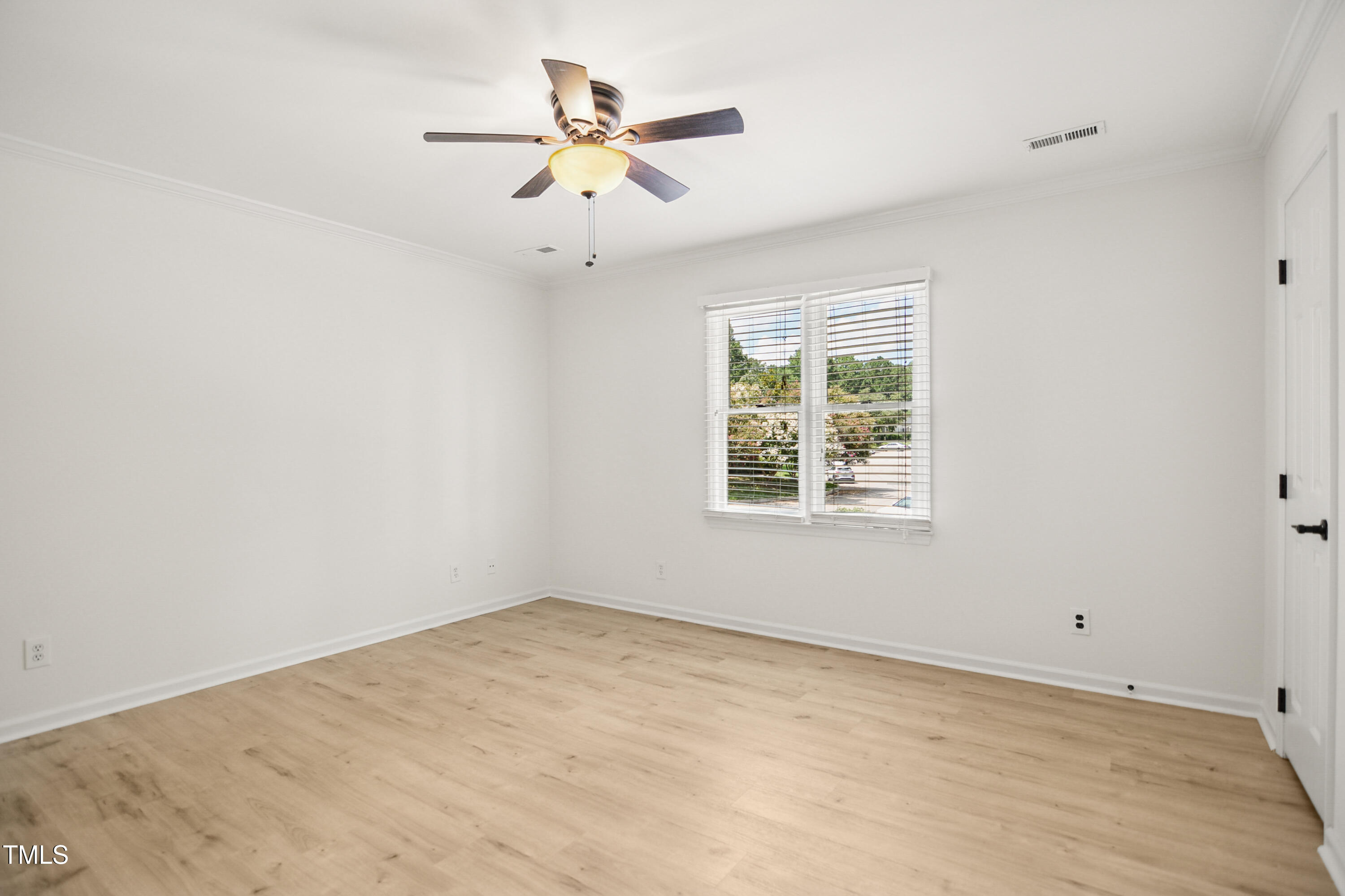 5436 Sharpe Drive Raleigh, NC 27612 - Photo 13 of 18 an empty room with window and ceiling fan