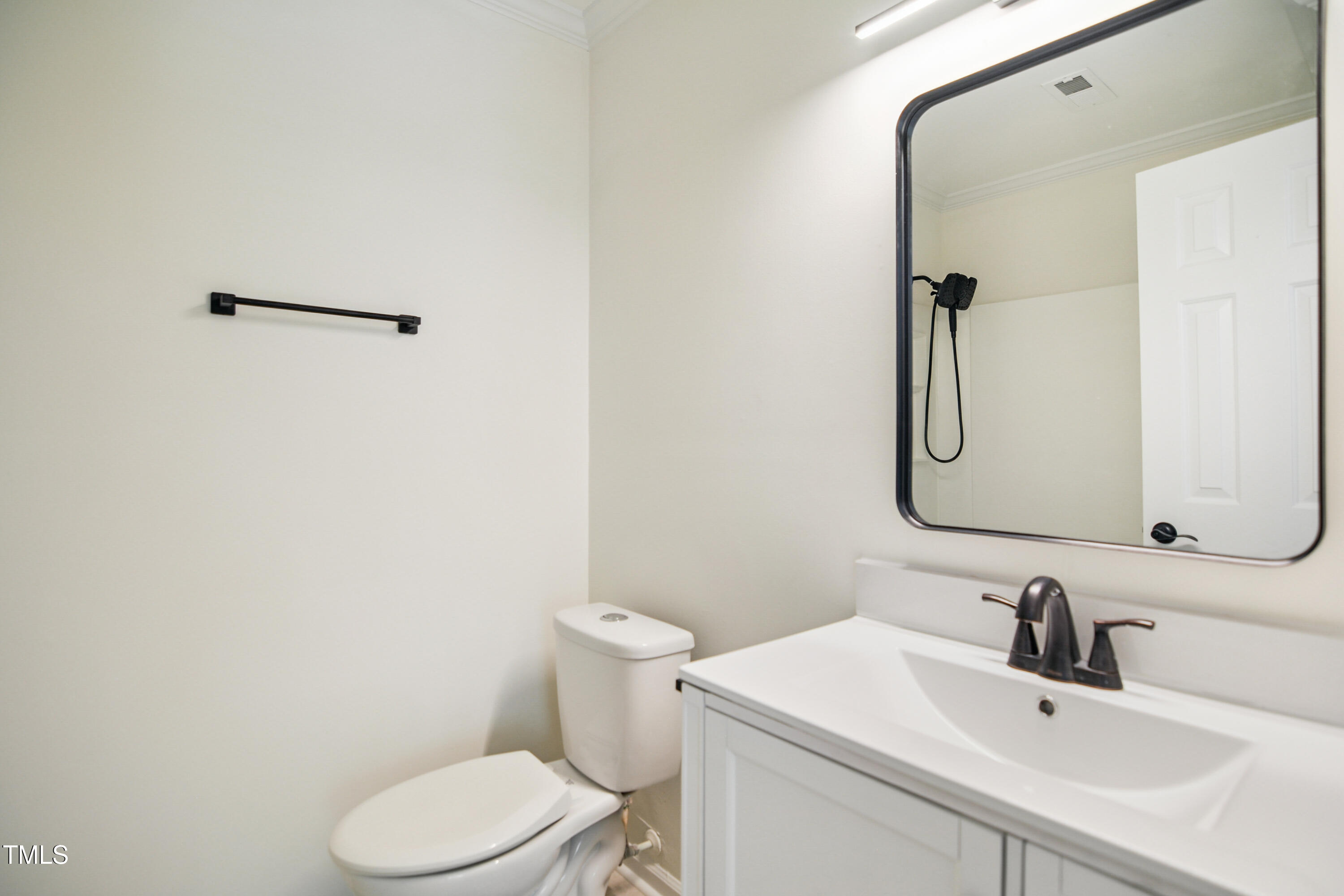 5436 Sharpe Drive Raleigh, NC 27612 - Photo 14 of 18 a bathroom with a sink mirror vanity and toilet