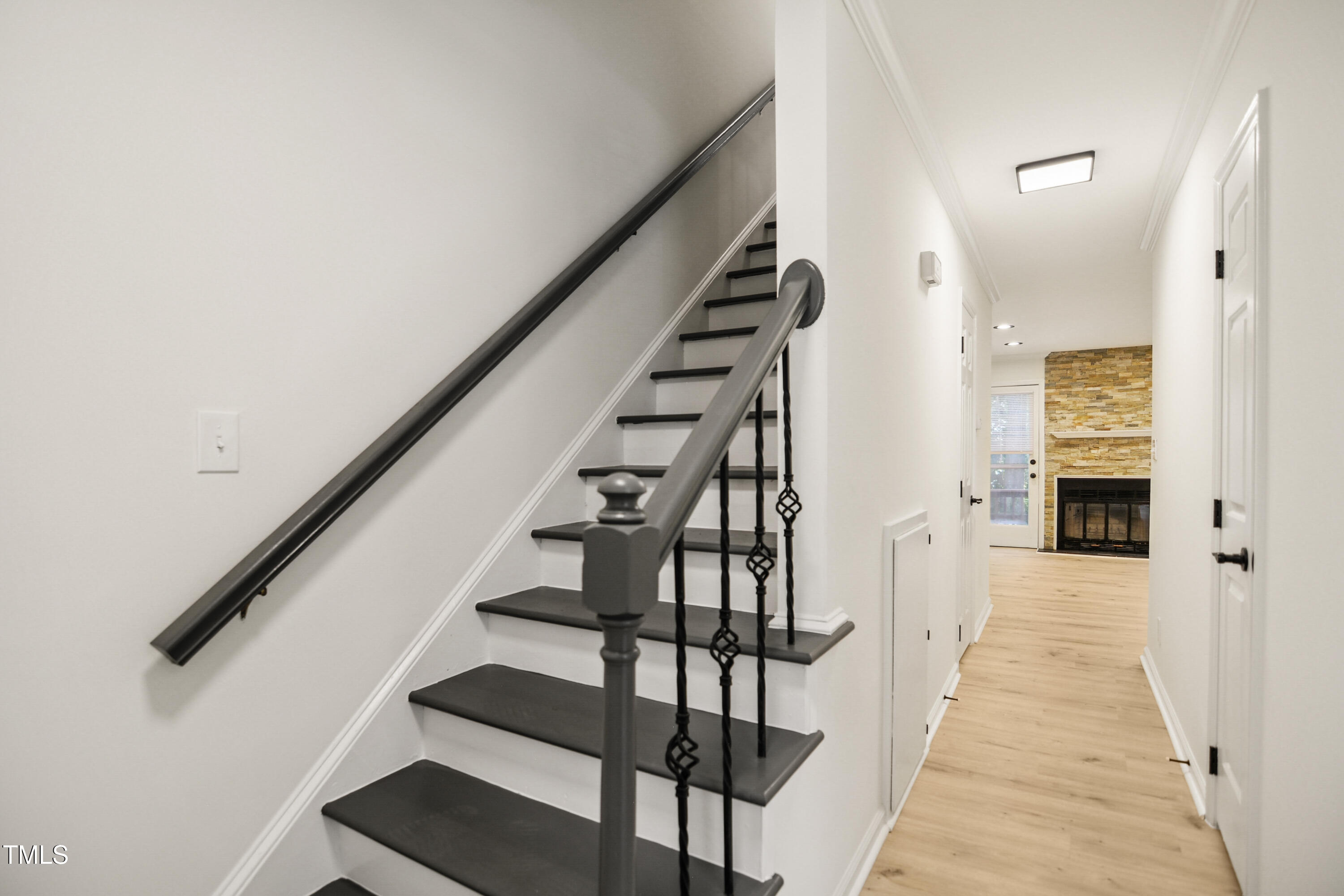 5436 Sharpe Drive Raleigh, NC 27612 - Photo 2 of 18 a view of a hallway with wooden floor and staircase