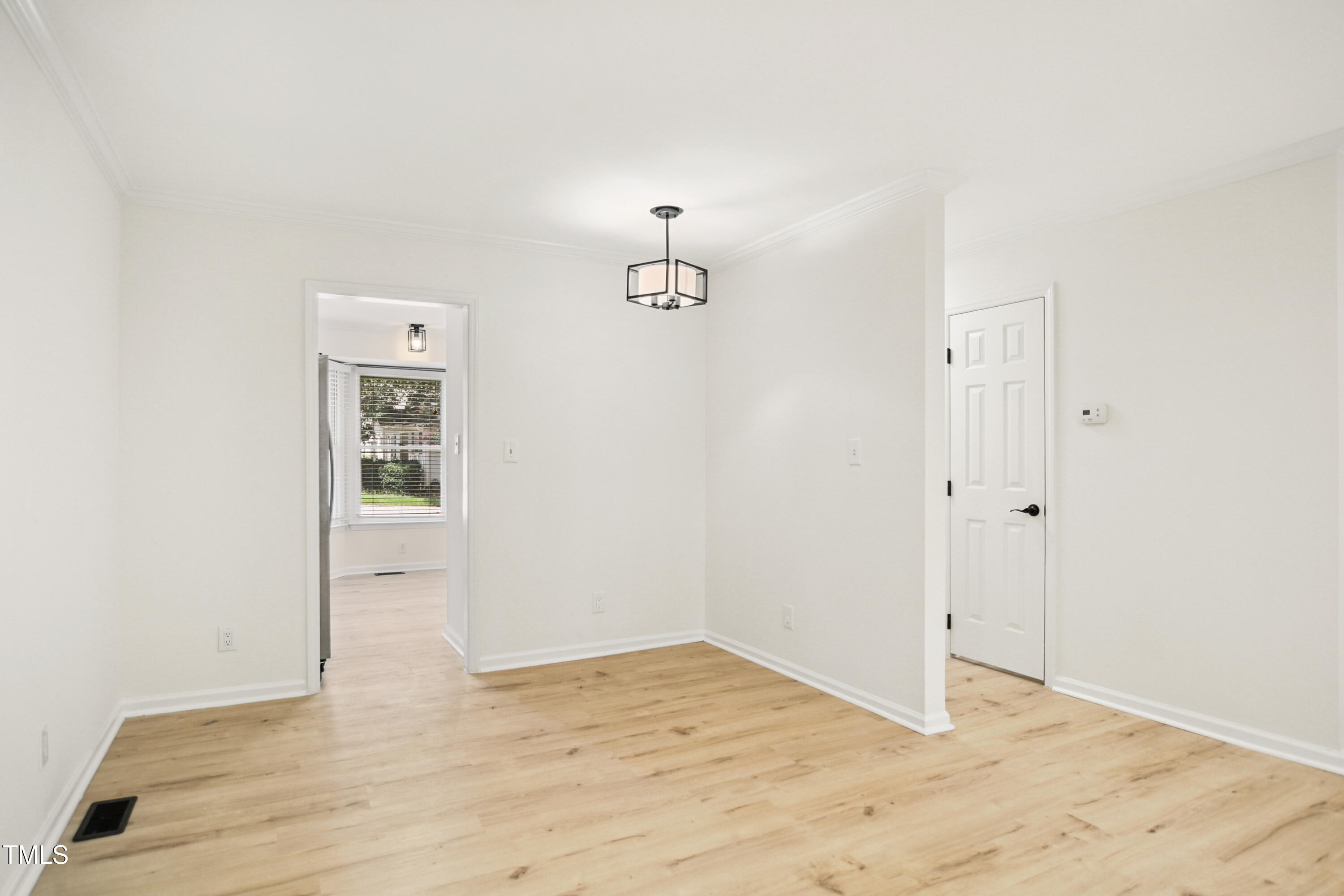 5436 Sharpe Drive Raleigh, NC 27612 - Photo 5 of 18 a view of empty room with wooden floor