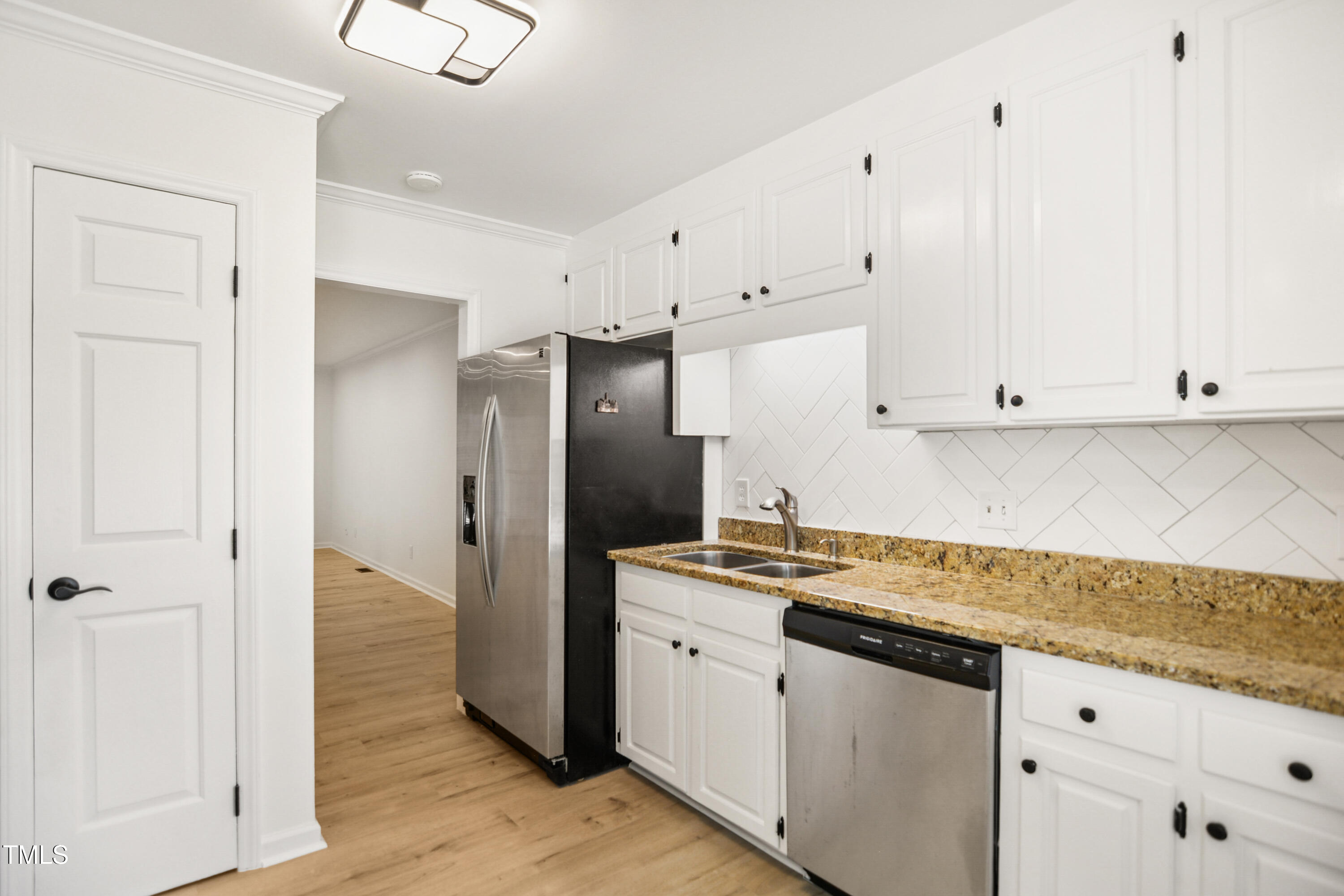 5436 Sharpe Drive Raleigh, NC 27612 - Photo 7 of 18 a kitchen with granite countertop cabinets stainless steel appliances and a counter space