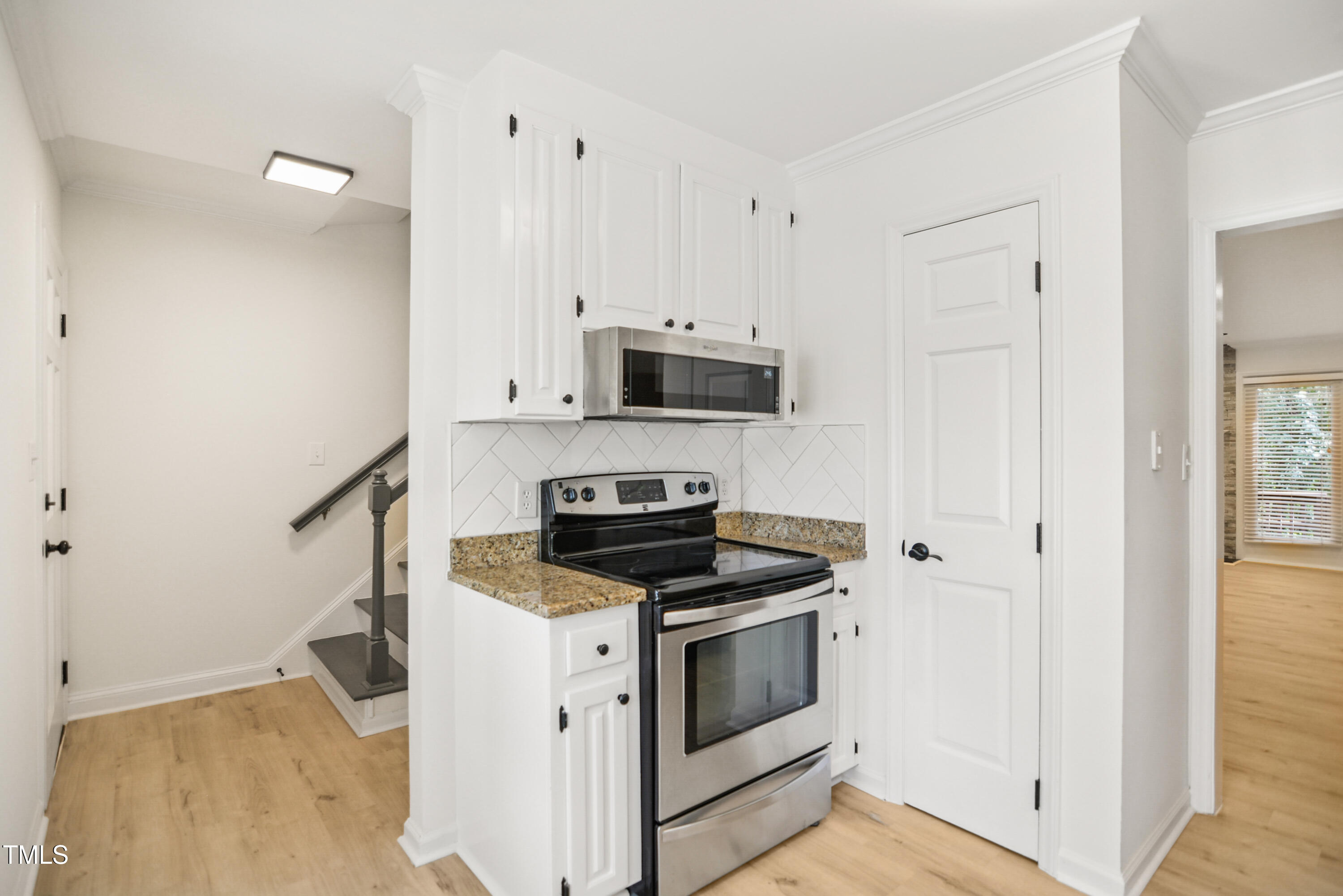 5436 Sharpe Drive Raleigh, NC 27612 - Photo 8 of 18 a kitchen with a stove and a microwave