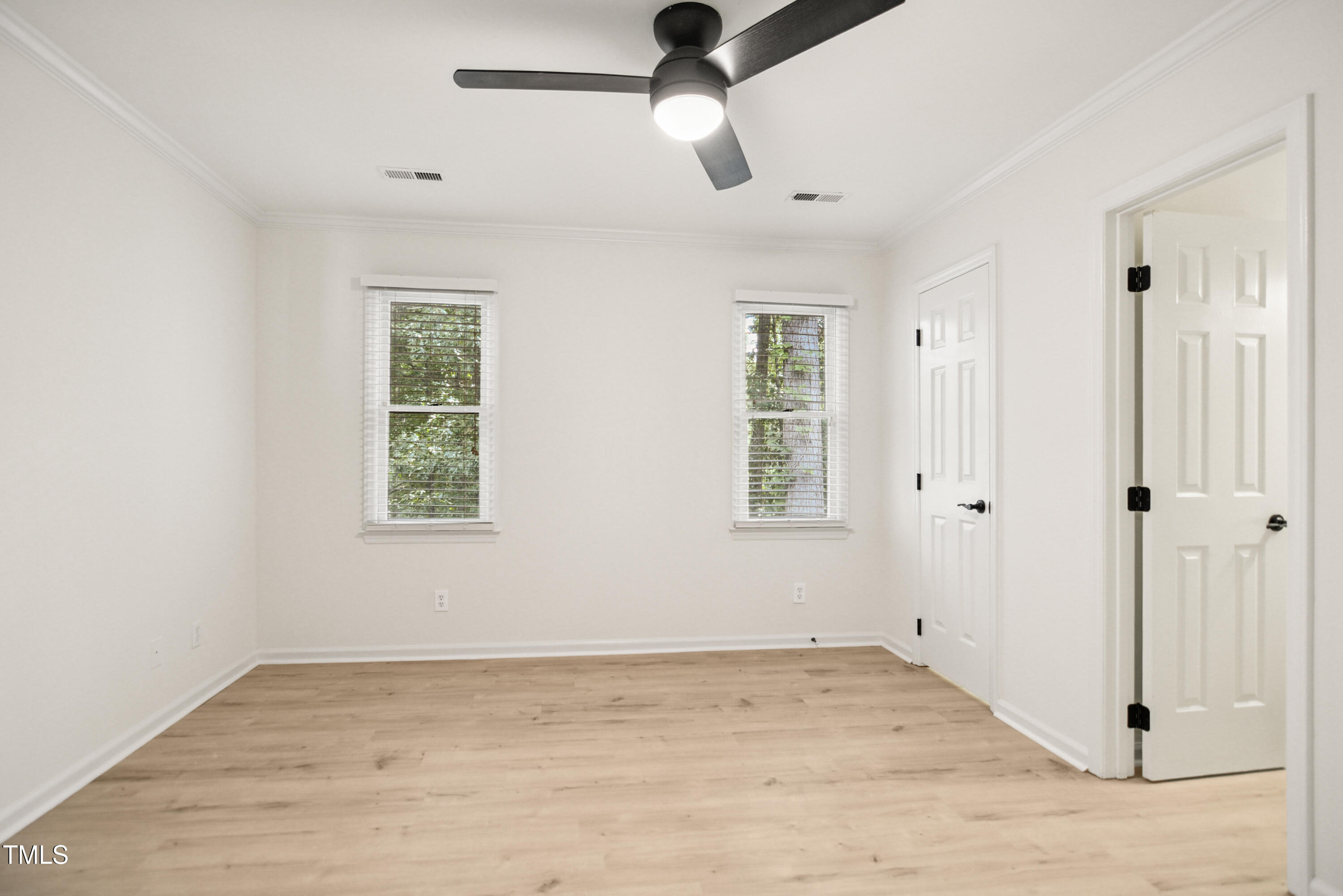5436 Sharpe Drive Raleigh, NC 27612 - Photo 10 of 18 wooden floor in an empty room with a window