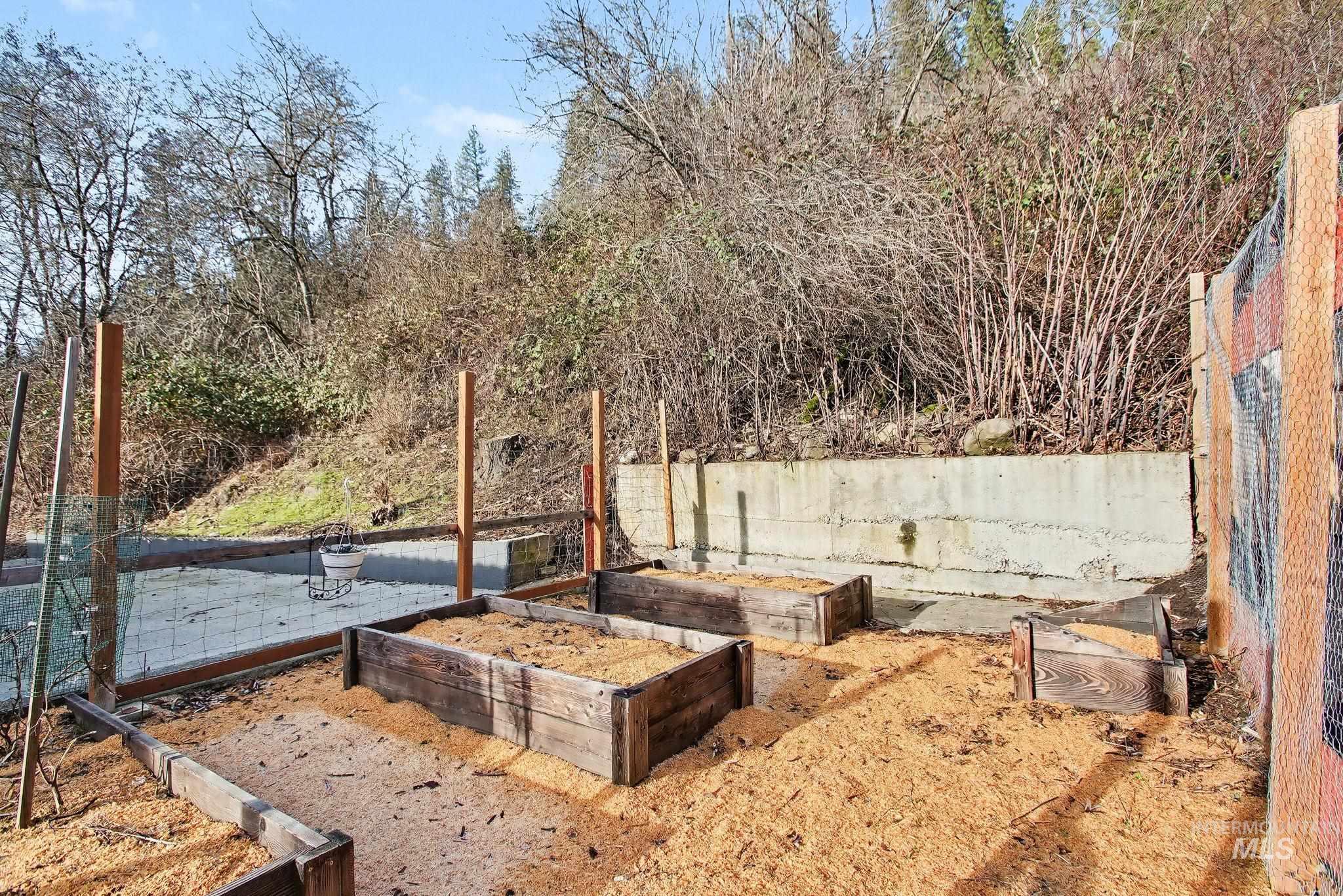 150 Elm Street Orofino, ID 83544 - Photo 31 of 36 Terraced garden area featuring multiple raised wooden planter boxes filled with wood chips