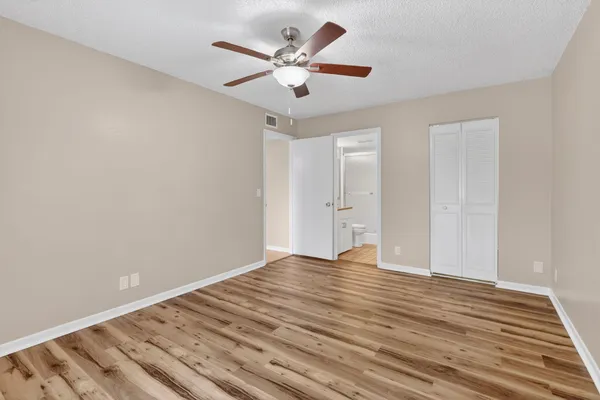 a view of room with wooden floor and ceiling fan