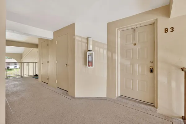 an empty room with windows and entrance