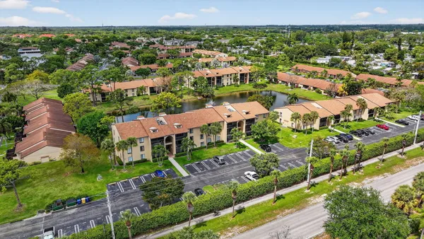 an aerial view of residential houses with outdoor space and lake view