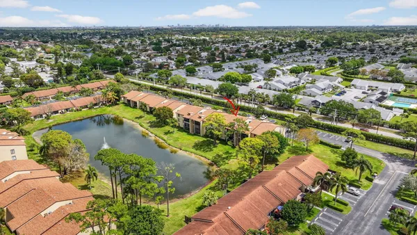 an aerial view of a house with a yard and lake view