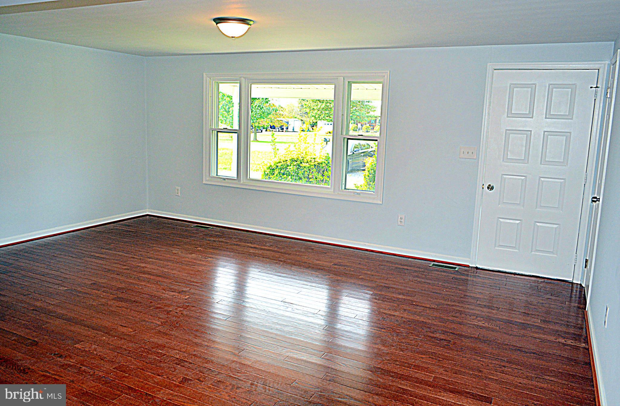 2085 Crouse Mill Road Taneytown, MD 21787 - Photo 3 of 19 an empty room with wooden floor and windows