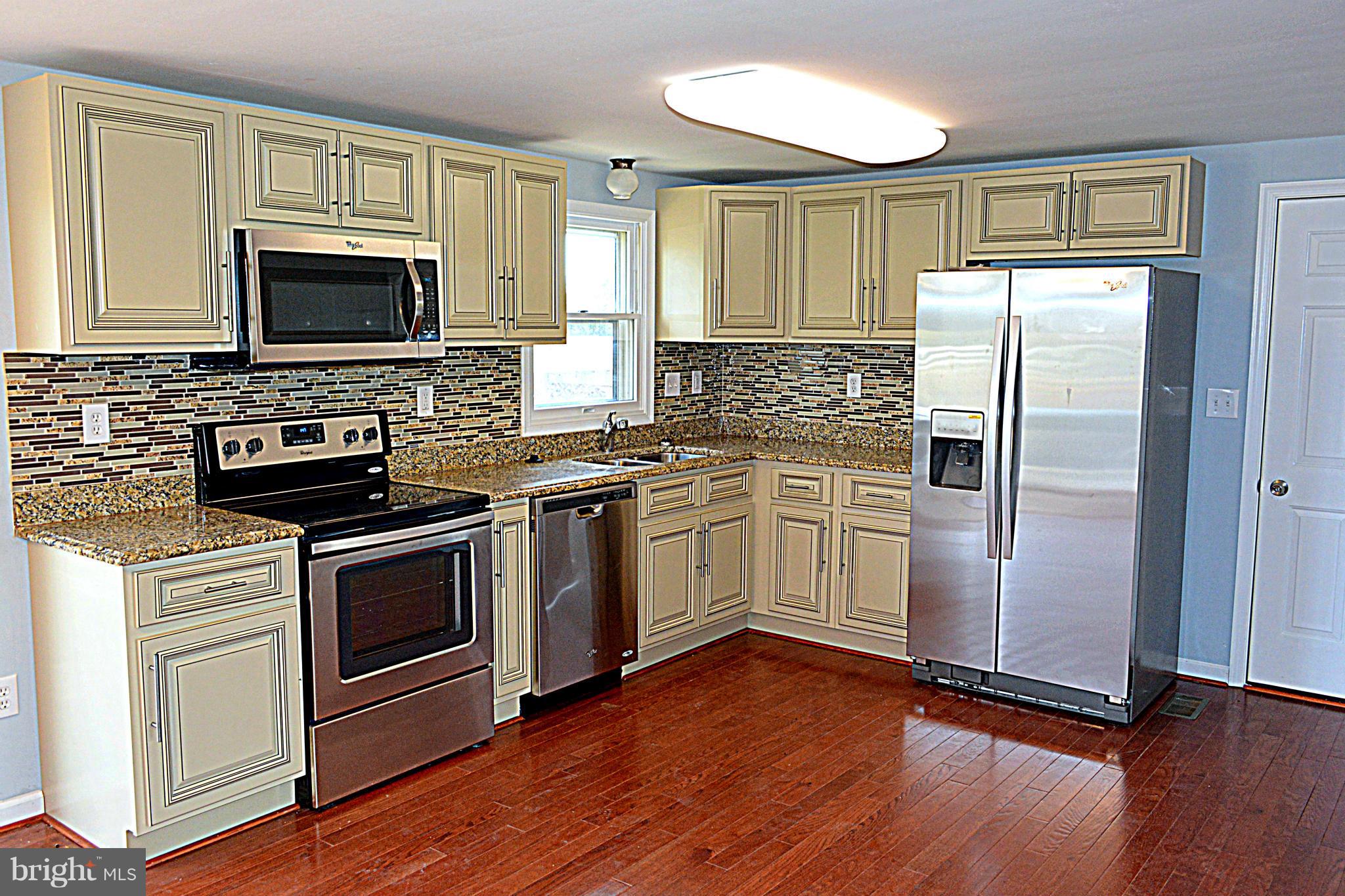 2085 Crouse Mill Road Taneytown, MD 21787 - Photo 4 of 19 a kitchen with a stove a microwave and a refrigerator