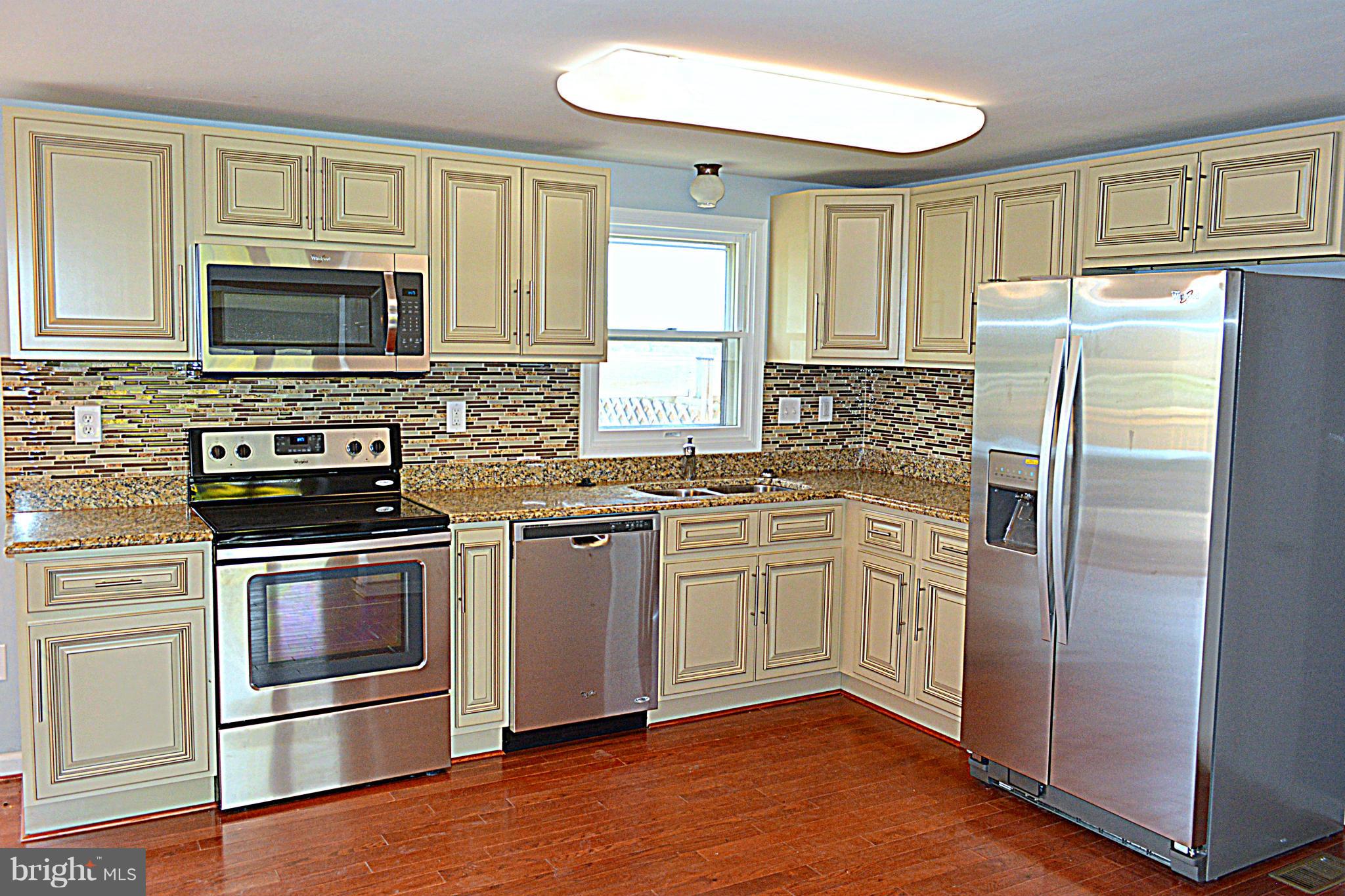2085 Crouse Mill Road Taneytown, MD 21787 - Photo 5 of 19 a kitchen with stainless steel appliances granite countertop a refrigerator stove and sink