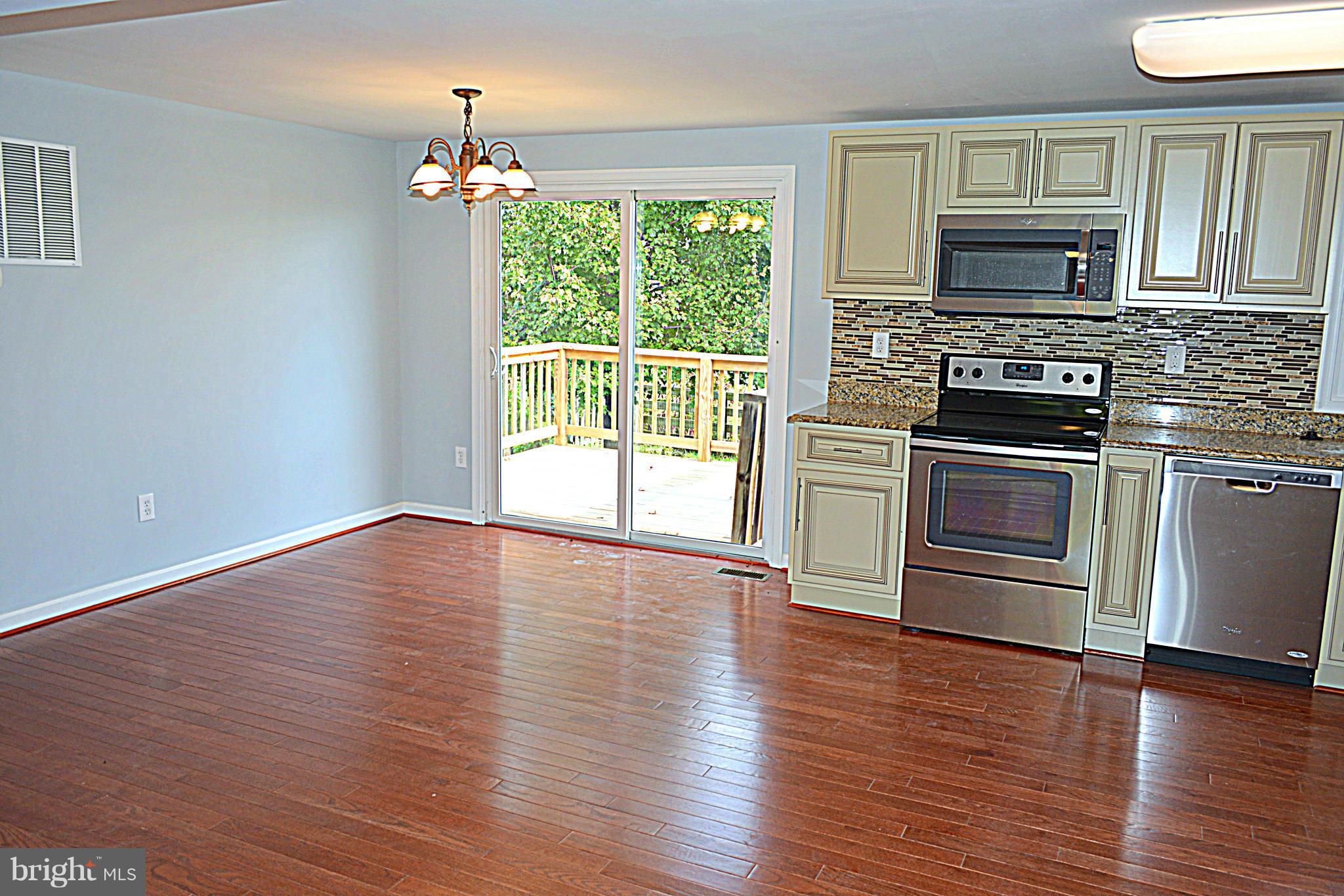 2085 Crouse Mill Road Taneytown, MD 21787 - Photo 6 of 19 a view of empty room with wooden floor and fireplace