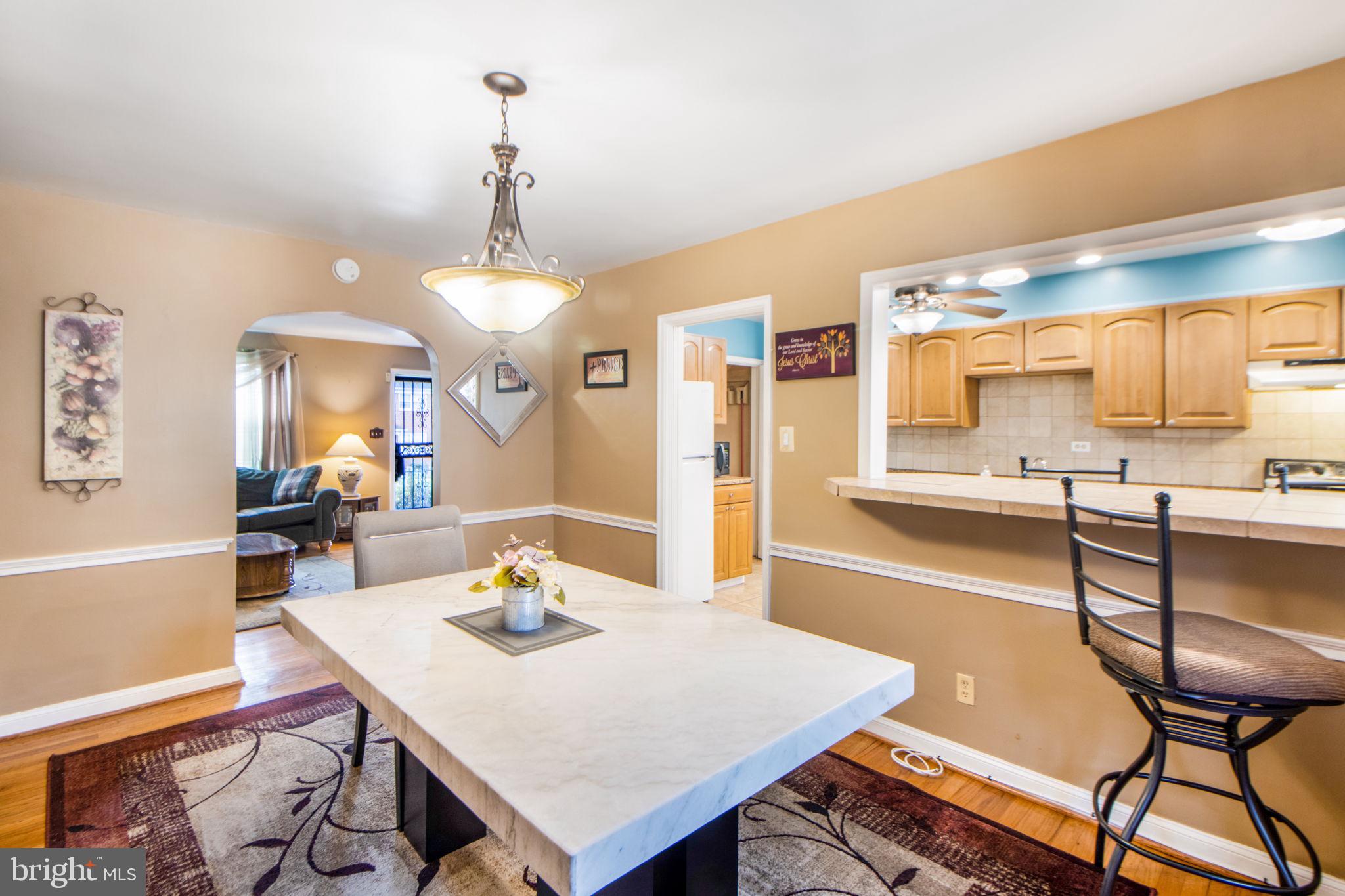 1903 Heathfield Road Baltimore, MD 21239 - Photo 11 of 30 a large kitchen with a table and chairs