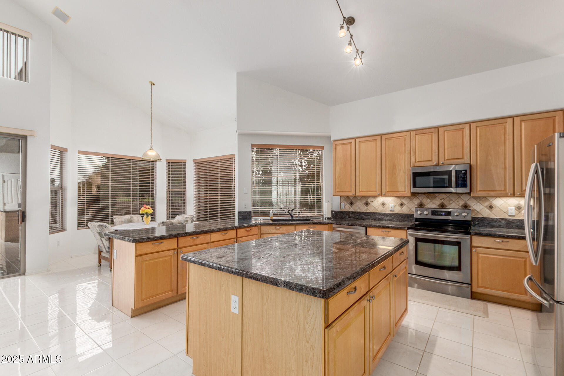 1111 South Sandstone Street Gilbert, AZ 85296 - Photo 15 of 59 a kitchen with stainless steel appliances granite countertop a stove a sink a microwave and a refrigerator