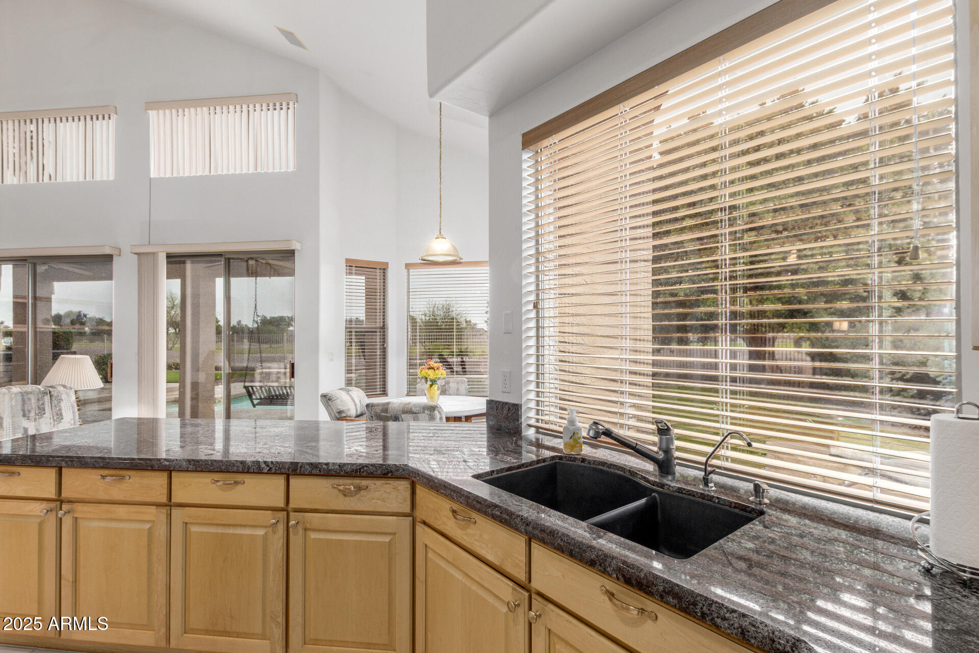 1111 South Sandstone Street Gilbert, AZ 85296 - Photo 16 of 59 a kitchen with a granite countertop sink and cabinets