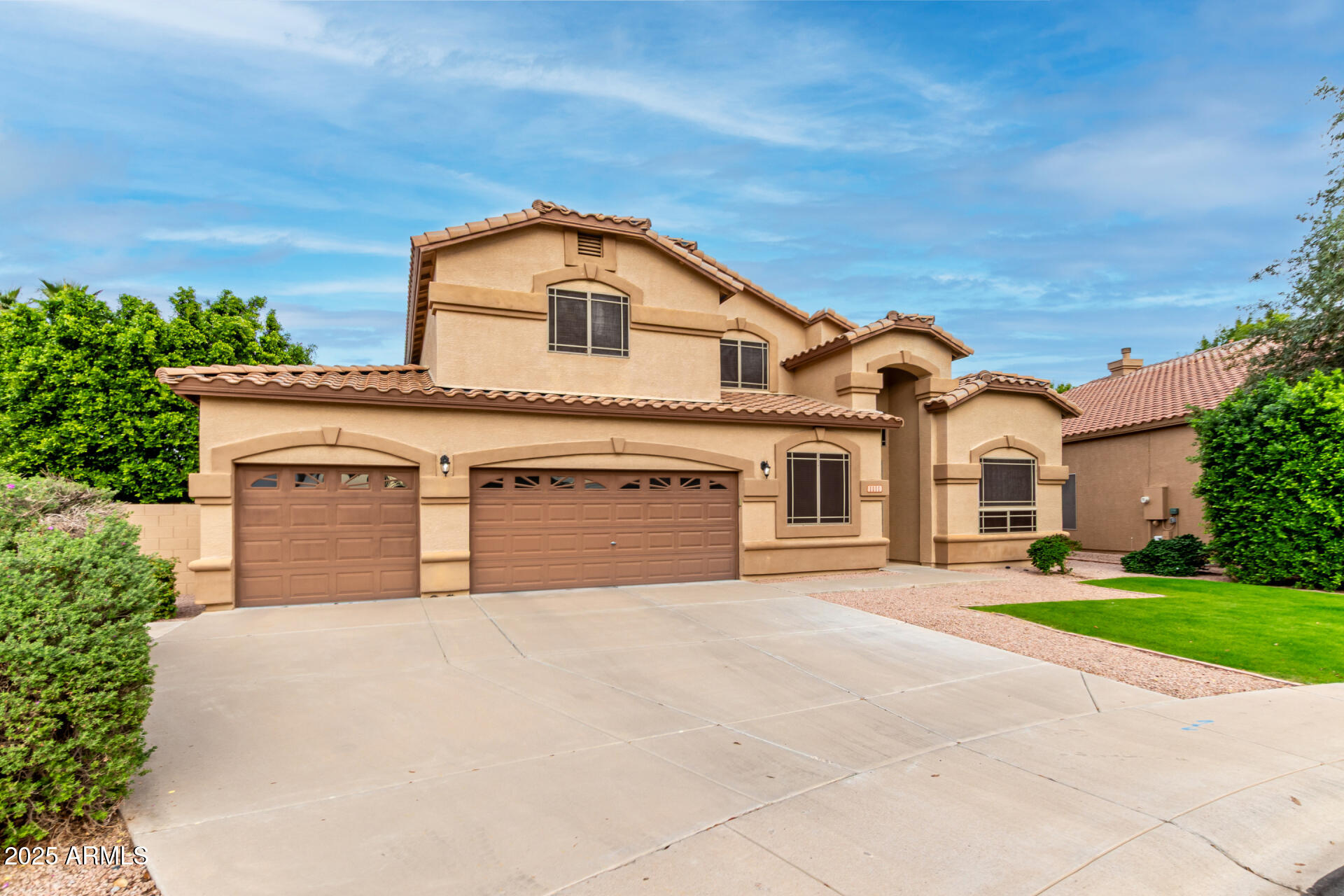1111 South Sandstone Street Gilbert, AZ 85296 - Photo 3 of 59 a front view of a house with a yard and garage